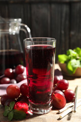 Delicious grape soda water with mint and berries on wooden table. Refreshing drink