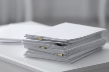 Stack of blank paper on white table