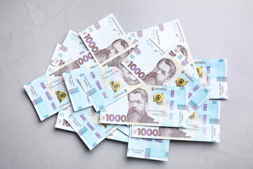 Ukrainian money on grey background, flat lay