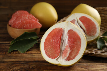 Fresh cut pomelo fruits on wooden table, closeup