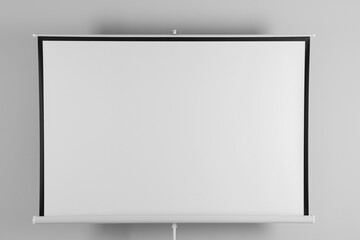 Obraz premium Blank projection screen near white wall indoors. Space for design