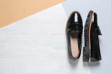 Stylish black women's shoes on color background, top view. Space for text