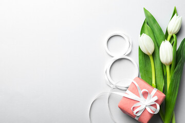 8 March card design with tulips, gift and space for text on light grey background, flat lay. International Women's Day