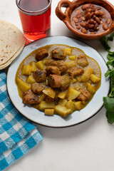 Mexican longaniza with green sauce and potato on white background