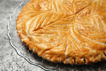 Traditional galette des rois on grey table, closeup
