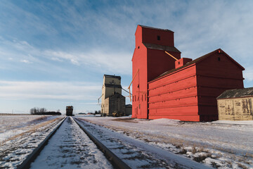 Fototapeta na wymiar Grain Silos On Winter Prairies 