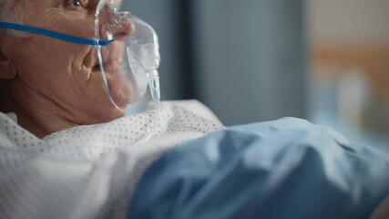 Hospital Ward: Portrait of Elderly Man Wearing Oxygen Mask Resting in Bed, Fully Recovering after Sickness and Successful Surgery. Old Man Remembering His Family, Friends, Happy Long Life