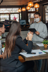 Successful young business people sharing ideas and smiling while working together on a project in a  coffee shop. .
