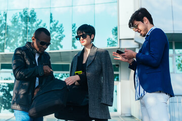 Three happy business colleagues talking outside the office