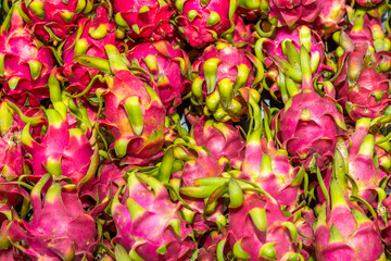 A pile of fresh dragon fruit for sale in the market