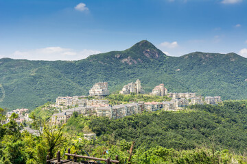 Obraz premium Modern castles on the top of mountain against cloudy sky in Overseas Chinese Town East (OCT East ) in Shenzhen, Guangdong, China.