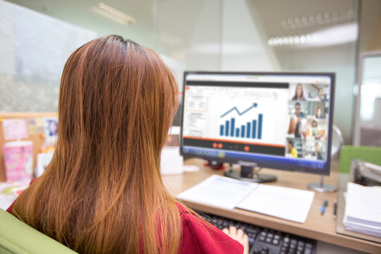 Business Women Watching Graphs From The Screen Of Computer Laptop For Online Meetings With Video Call Program. Concepts Of Conference Or Teaching Students ELearning And Work From Home.