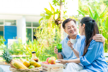 Retirement Senior Couple having coffee and toast in garden morning