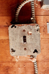 Electrical Switch in in Off Mode, Set in Metal Junction Box on Wooden Surface with BX Cable