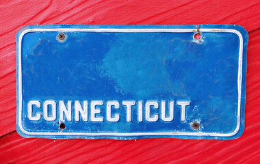 Classic license plate on red background.