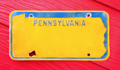 Classic license plate on red background.