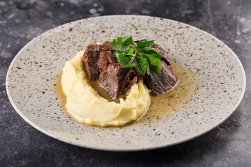beef course with mashed potatoes and herbs. Photo for menu. 