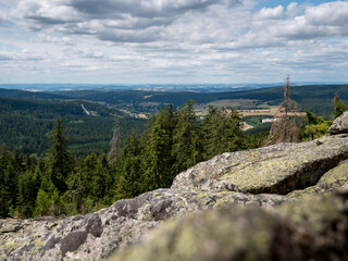 Fototapeta premium Haberstein huge natural block field of granite rocks on Schneeberg in Fichtel Mountains, Baravria in Germany with a cloudy sky during summer season. A lot of tourists are hiking to enjoy this view.
