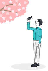 Man taking a picture of cherry blossoms