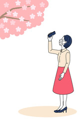 woman taking a picture of cherry blossoms