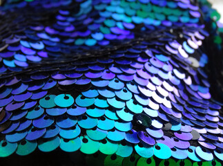 background of green,blue and purplesequins close up