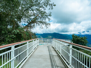 skywalk in the forest surrounded by mountains