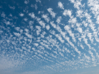 Naklejka na ściany i meble Blue sky with striped clouds on a sunny day texture perfect for sky replacement