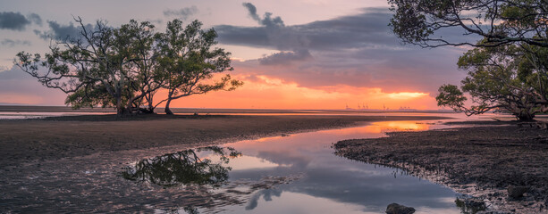 Beautiful Panoramic Seaside Sunrise with Cloud Reflections
