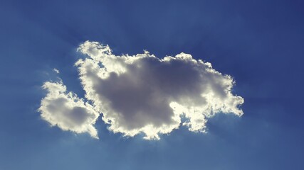 the sun's rays break through the cloud in the blue sky © Paulina