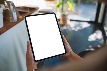 Mockup image of a woman holding digital tablet with blank white desktop screen