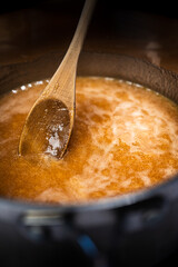 Liquid salted caramel in a pot bubbling