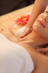 A young women lying in bed enjoying massage