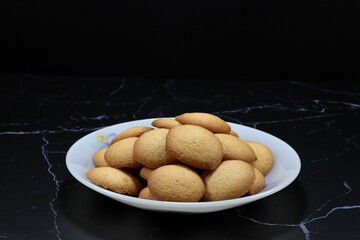 Pile of classic cookie serving on the plate. Famous traditional sweet dessert in Asia party. 