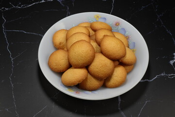 Pile of classic cookie serving on the plate. Famous traditional sweet dessert in Asia party. 