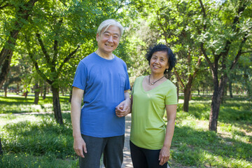 Two old people exercising in the park