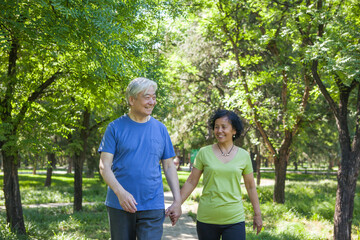 Two old people exercising in the park