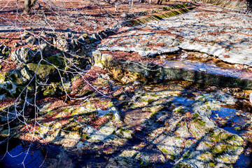 Winter scene of dry riverbed of rocks and stones