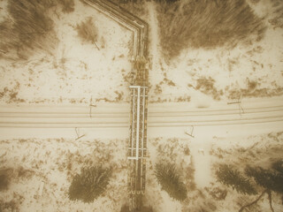 the intersection of pipelines of heating networks and the railway filmed from a drone on a foggy winter day