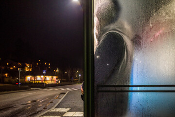 Stockholm, Sweden A man waits for a bus in the Lidingo suburb in the rain.