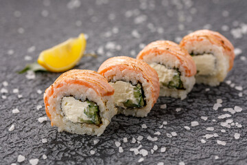 Sushi rolls Baked Philadelphia on textured still life background. Restaurant concept. Close-up.