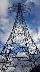 electricity pylons cords  blue sky clouds