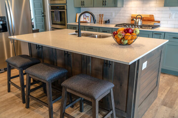 Kitchen island with healthy fresh fruits faucet and sink on the countertop