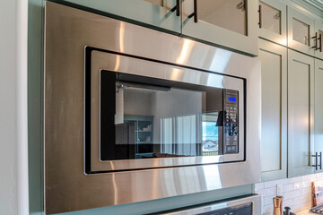 Electric microwave oven that heats and cooks food inside kitchen of home