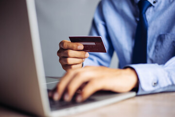 Online payment hands holding credit card and using laptop. Online shopping concept.