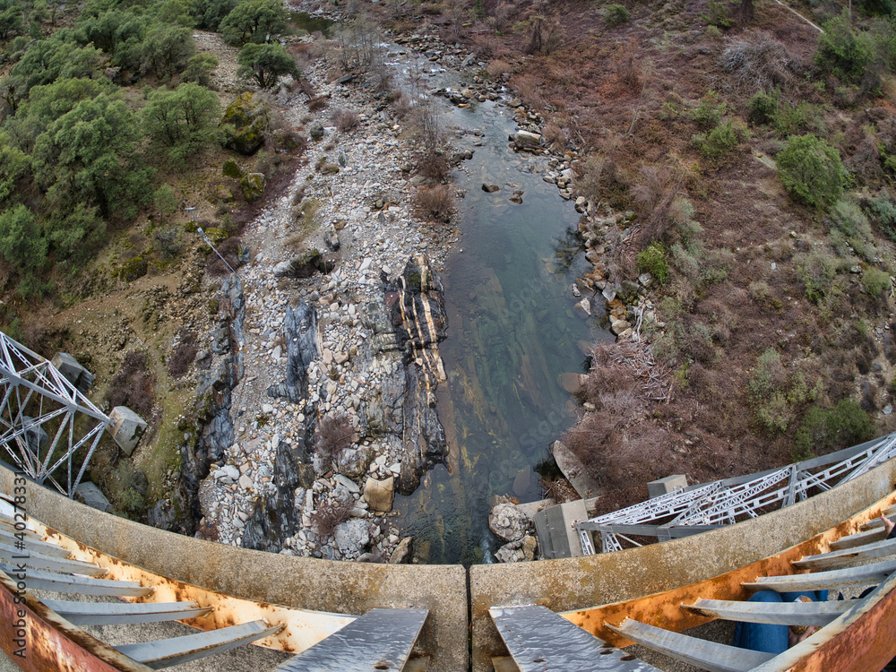 Poster Looking down off rusty bridge over river