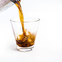 Close-up Cola in glass with ice on white background. - 402783952