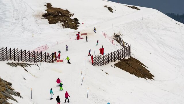 Winter sports, snowboarders on the marked downhill slope