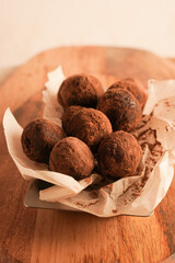 Close-up of chocolate truffles on a wooden plank. Keto dessert