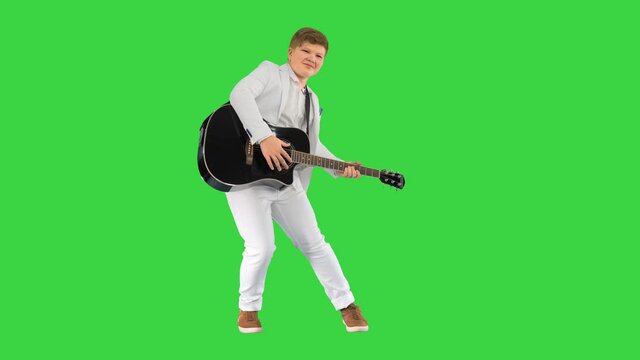 Boy moves like Elvis with guitar on a Green Screen, Chroma Key.