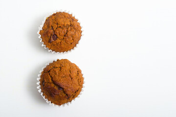 pair of chocolate muffins on white table